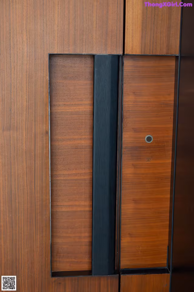 A close up of a wooden door with a number on it.