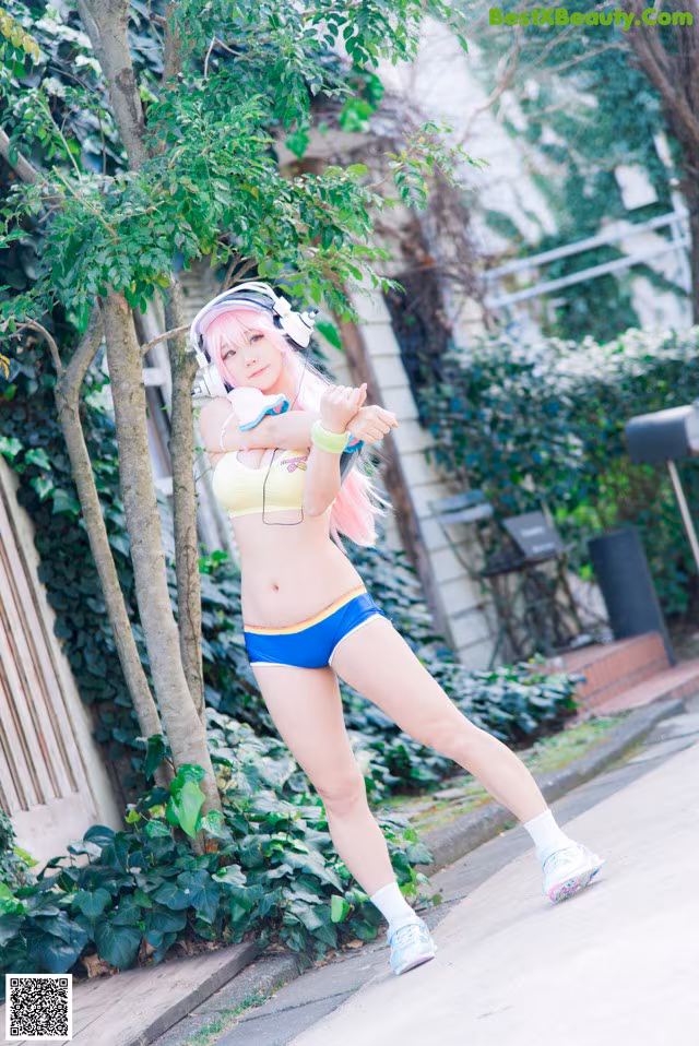 A woman in a bikini and headphones is posing for a picture.