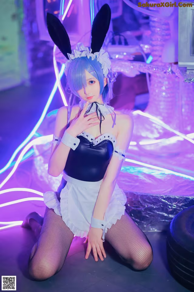 A woman in a bunny costume sitting on the floor.