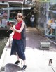 A woman standing on a dock holding a fishing rod.