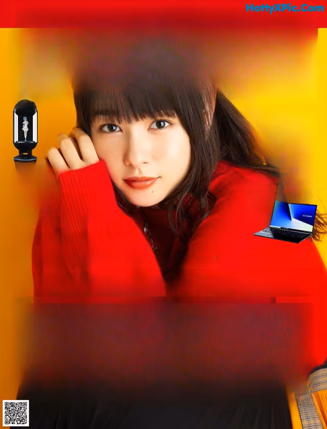 A magazine with a picture of a woman in a red sweater.