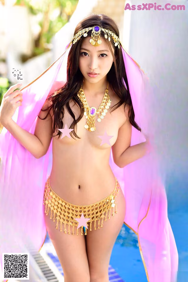 A woman in a bikini standing next to a swimming pool.